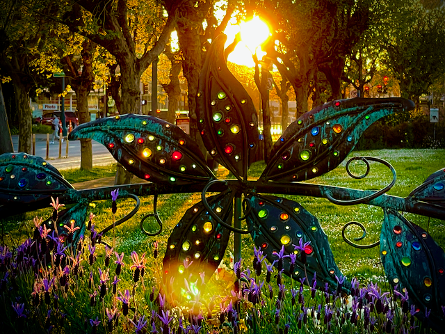 A metal and glass floral sculpture at sunset in San Francisco.